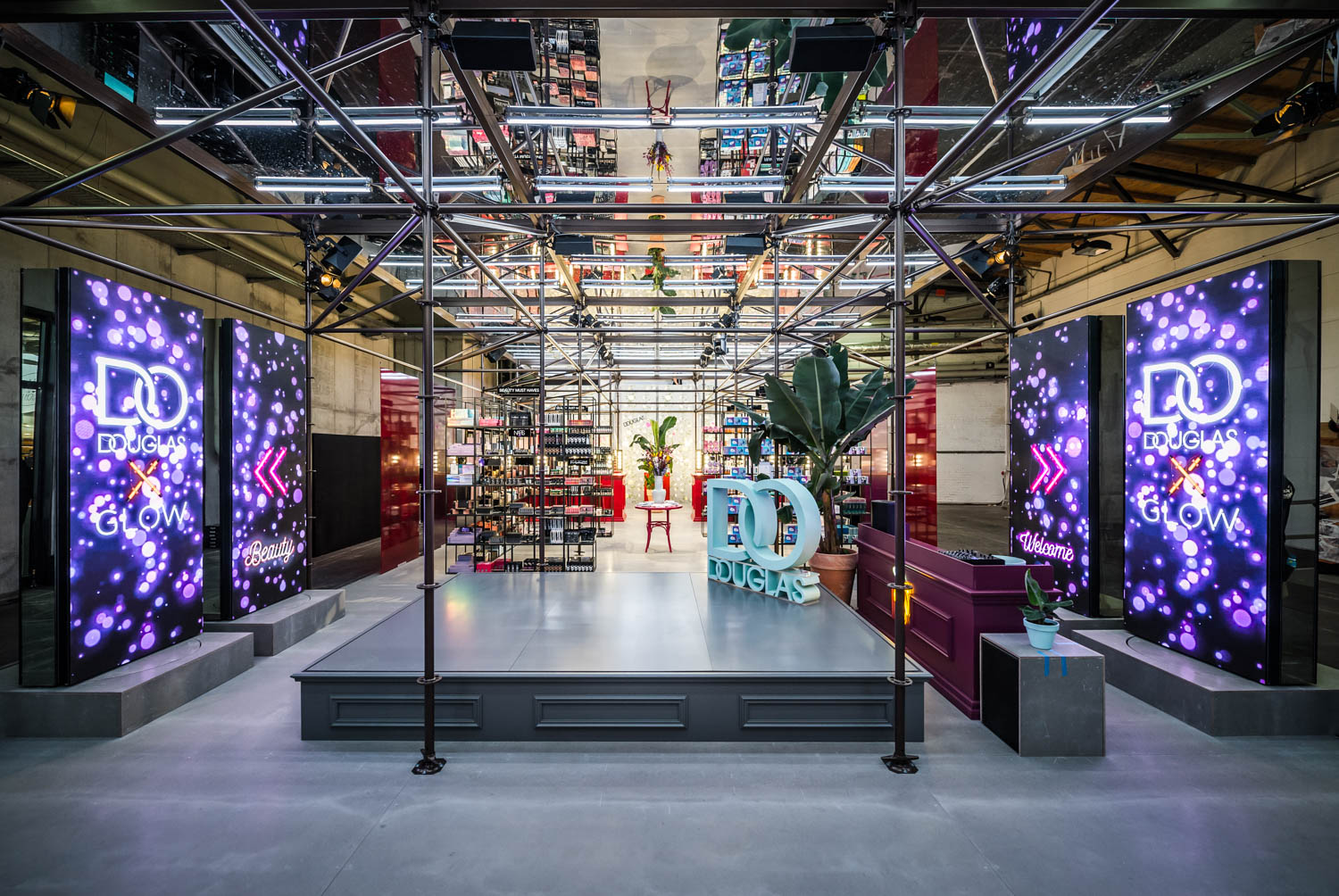 Douglas × Glow booth with revolving LED panels, daytime